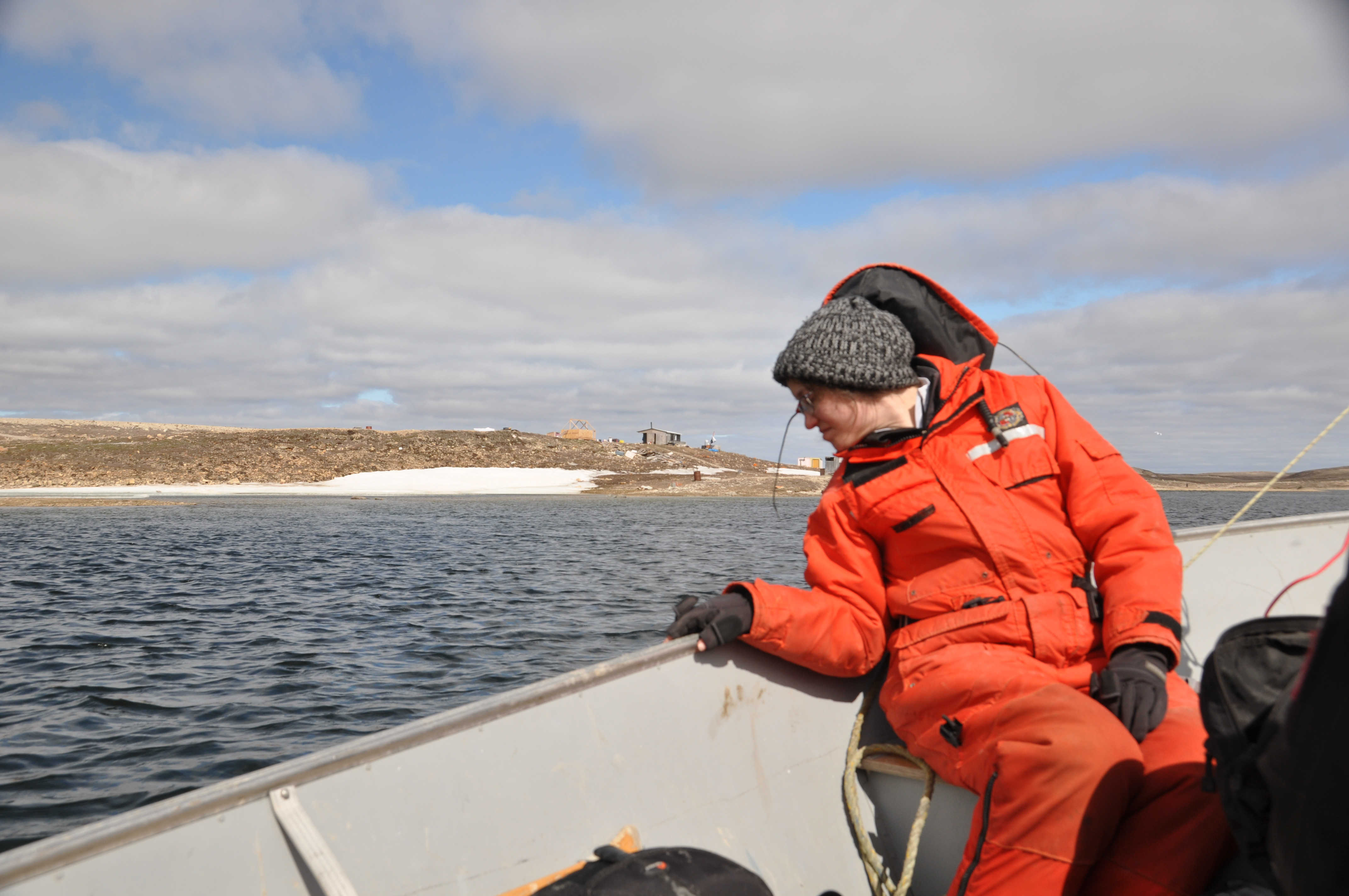 Riding in the chase boat, while wearing a survival suit.