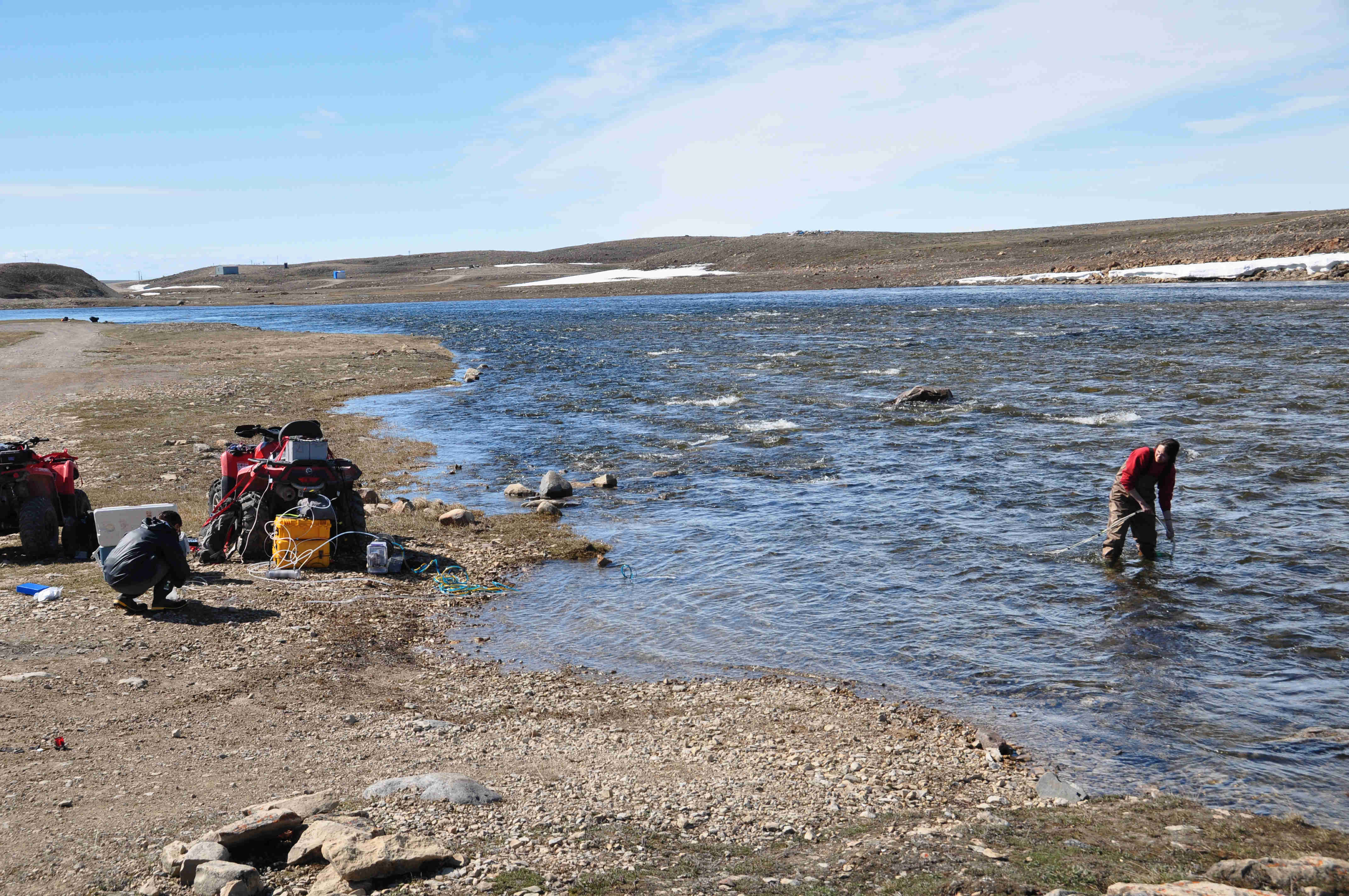 Collecting samples in Cambridge Bay with a shore-pump
