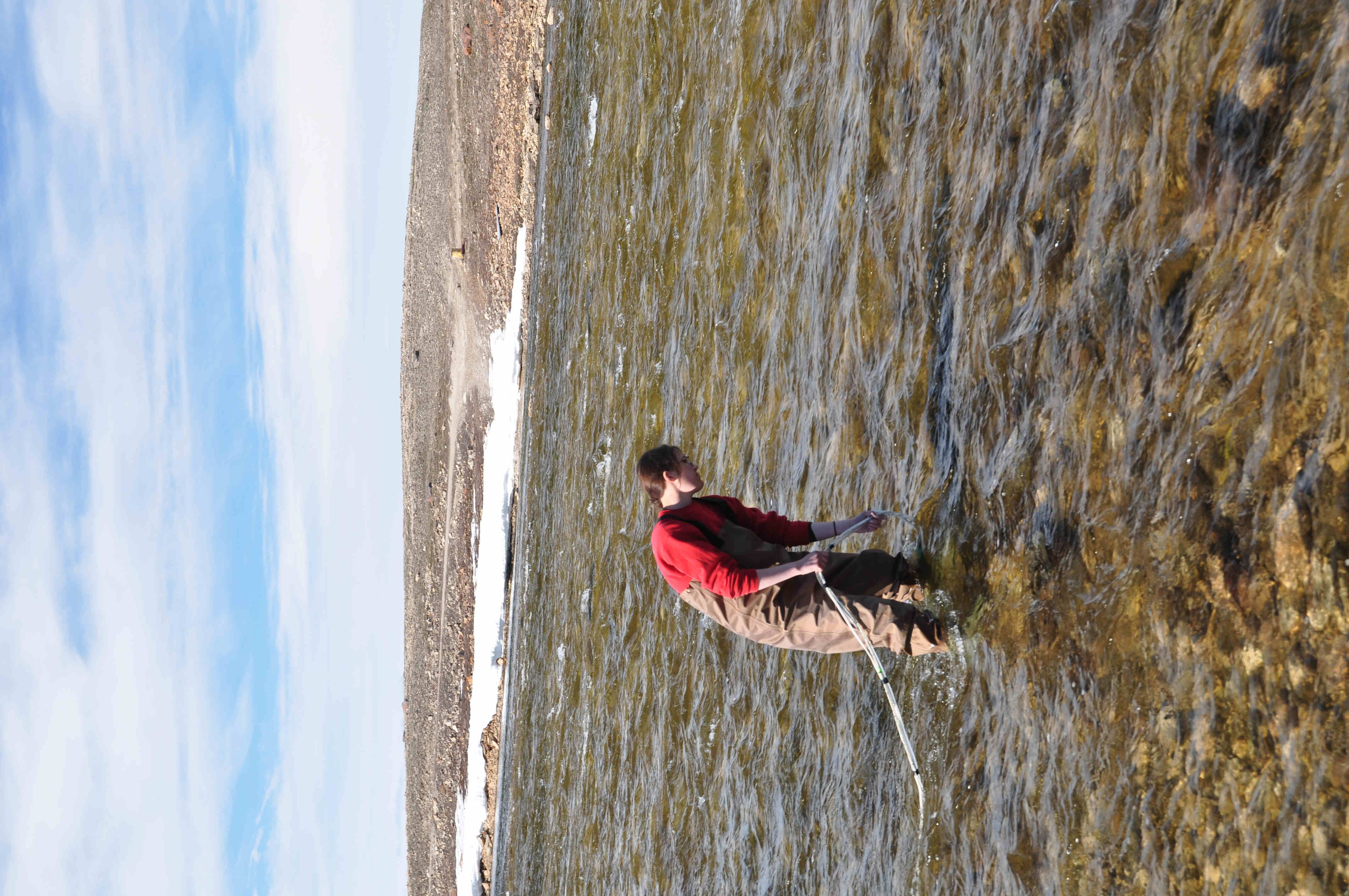 Wading from the shore for a measurement.